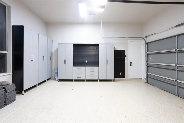 a view of an empty room with closet and a window