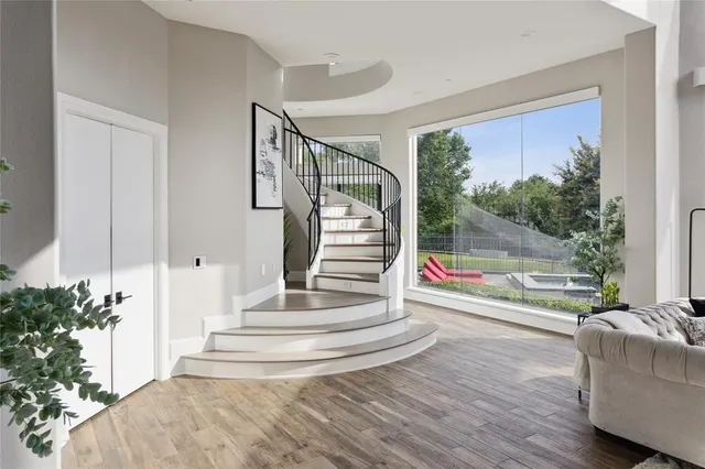 a view of entryway and hall with wooden floor