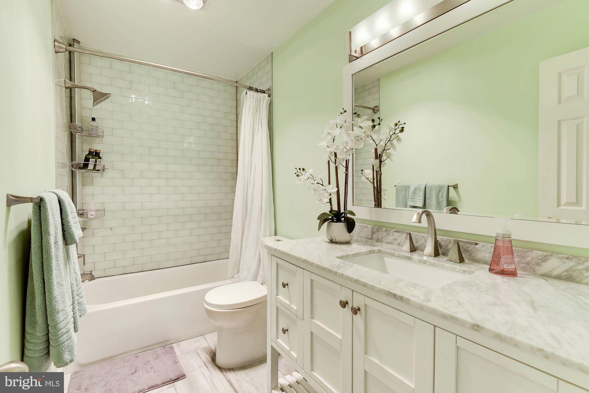 1304 19th Road South Arlington, VA 22202 - Photo 19 of 25 a bathroom with a granite countertop sink a toilet and shower