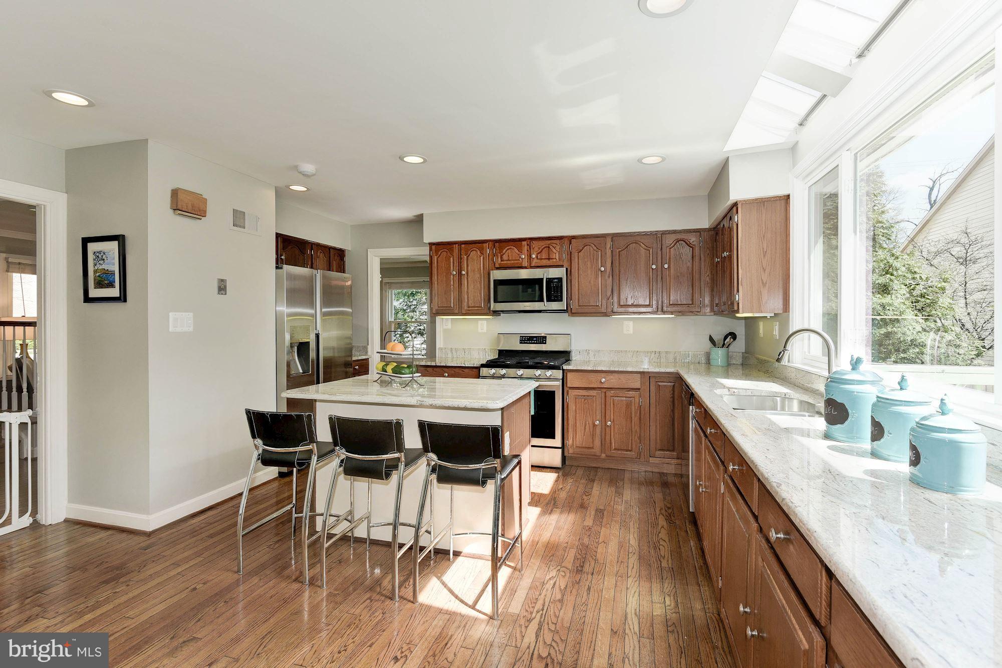 1304 19th Road South Arlington, VA 22202 - Photo 10 of 25 a large kitchen with a table and chairs in it