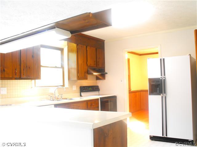 4641 Treely Road Chester, VA 23831 - Photo 4 of 11 a kitchen with a refrigerator and a sink