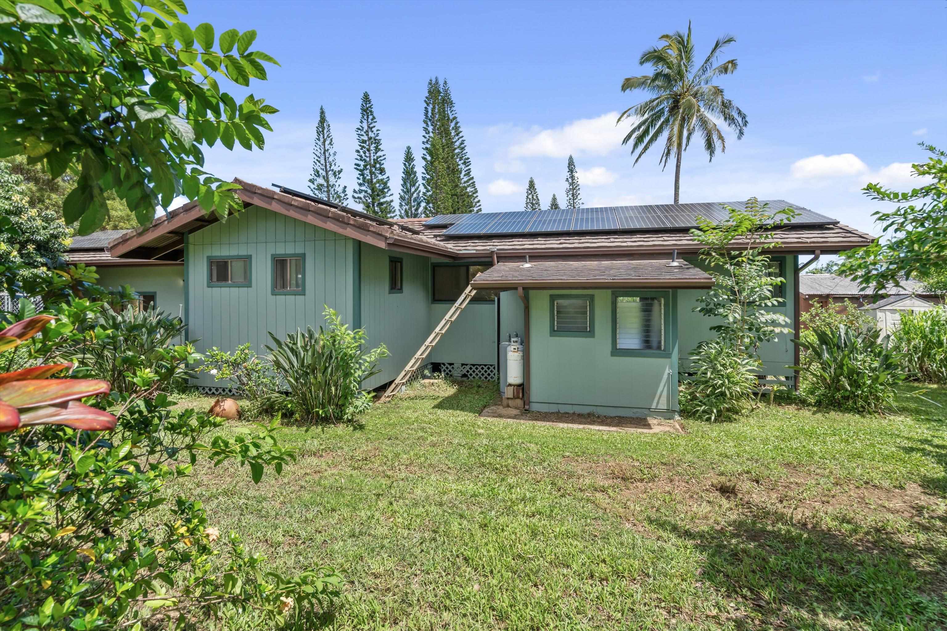 145 South Holokai Road Haiku, HI 96708 - Photo 41 of 50 a view of a house with a yard and potted plants