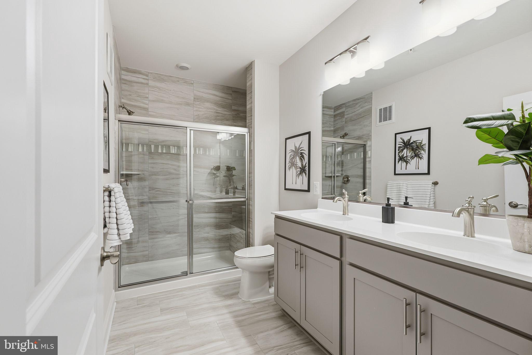 402 Bold Ruler Court, Unit 202 Havre de Grace, MD 21078 - Photo 6 of 17 a bathroom with a double vanity sink toilet and shower