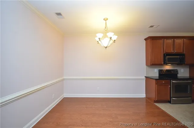 a view of a kitchen with a sink and dishwasher with wooden floor