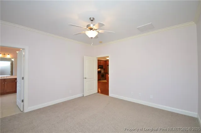 an empty room with closet and a chandelier fan
