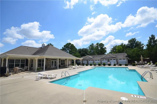 a view of a patio with couches table and chairs and potted plants