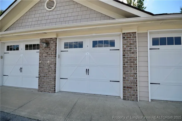a front view of a house with cars parked