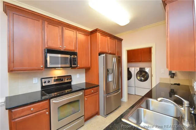 a kitchen with stainless steel appliances granite countertop a refrigerator stove and microwave