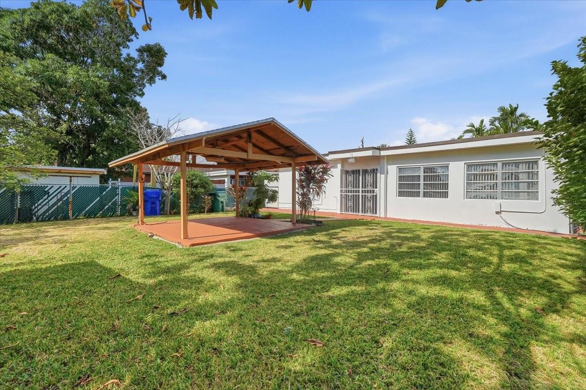 5580 Southwest 2nd Street Miami, FL 33134 - Photo 21 of 29 a view of a house with pool and a yard
