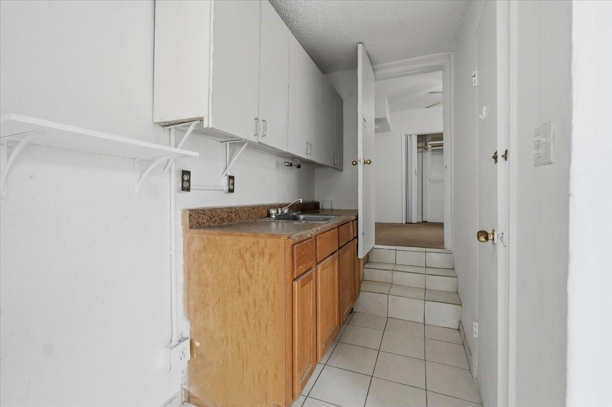 5580 Southwest 2nd Street Miami, FL 33134 - Photo 27 of 29 a utility room with cabinets washer and dryer
