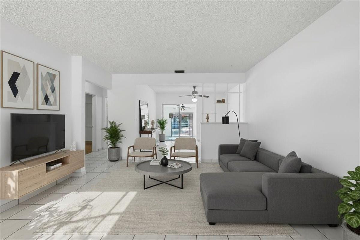 5580 Southwest 2nd Street Miami, FL 33134 - Photo 9 of 29 a living room with furniture a flat screen tv and white walls