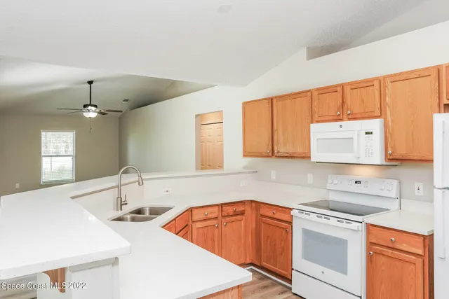 a kitchen with stainless steel appliances a sink stove and cabinets
