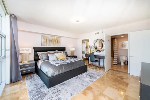 a kitchen with stainless steel appliances kitchen island granite countertop a refrigerator and a stove top oven