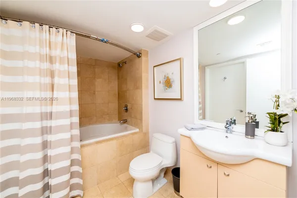 a kitchen with stainless steel appliances kitchen island granite countertop a refrigerator and a sink