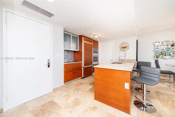 a living room with furniture a flat screen tv and a floor to ceiling window