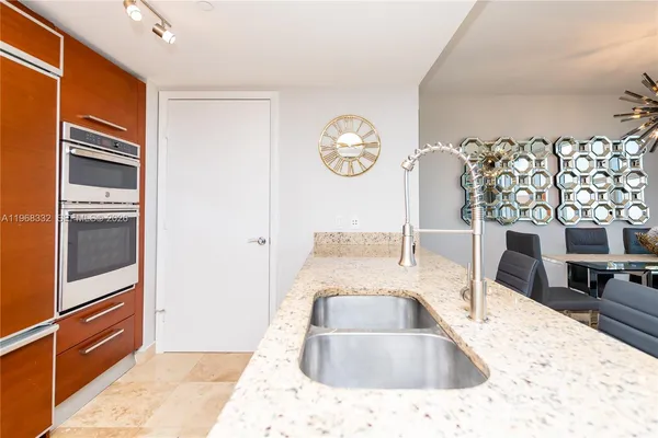 a living room with furniture a large window and a wooden floor