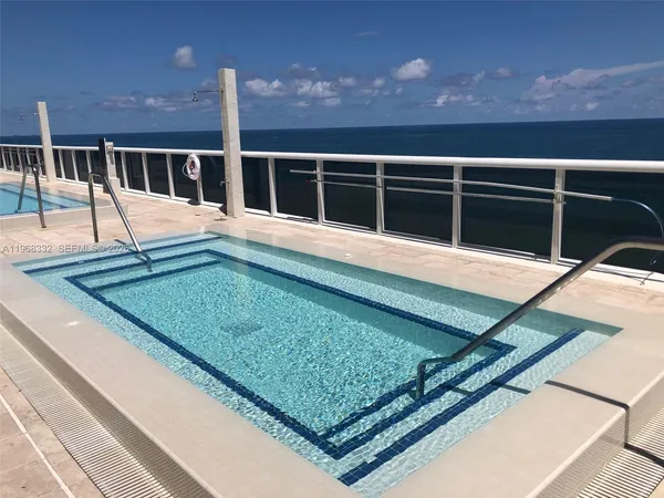 a living room with fireplace furniture and a large window