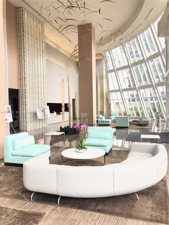 a view of a kitchen with an entryway and wooden floor