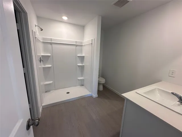 a bathroom with a shower and a sink