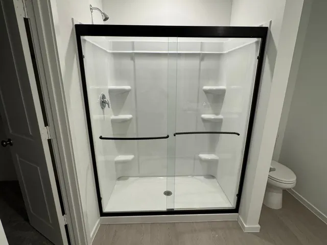 a bathroom with a glass shower door