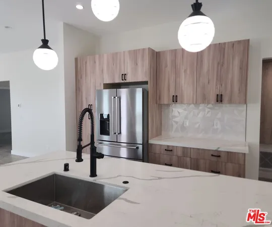 a kitchen with a refrigerator and a sink