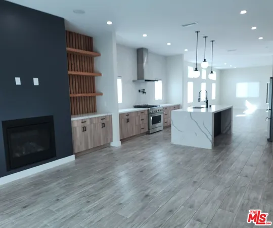 a large kitchen with kitchen island a sink stainless steel appliances and cabinets