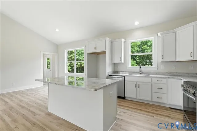 a view of empty room with wooden floor and window