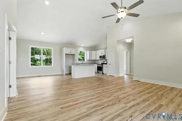a kitchen with wooden floors white cabinets and wooden floor