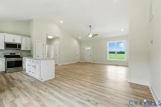 a kitchen with granite countertop a sink stove and refrigerator
