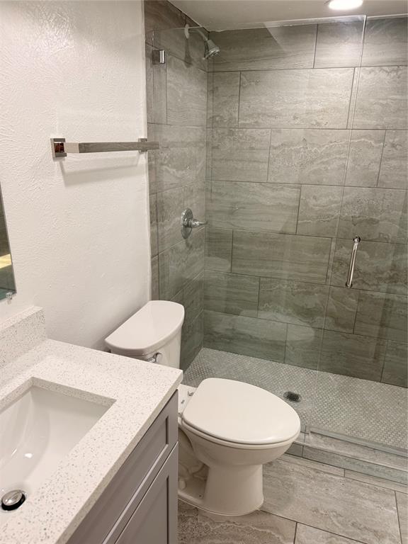 3925 Inwood Road, Unit 1017 Dallas, TX 75209 - Photo 12 of 23 a bathroom with a sink a toilet and shower