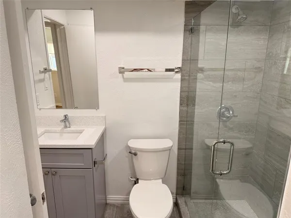 a bathroom with a toilet sink and shower