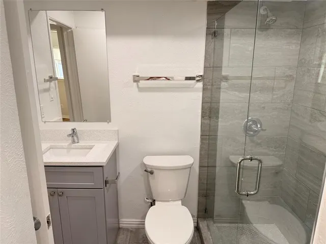 a bathroom with a toilet sink and shower