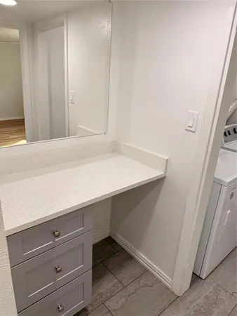 a room with a wooden floor and cabinets