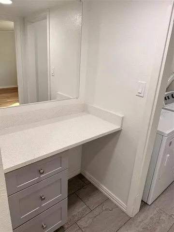a room with a wooden floor and cabinets