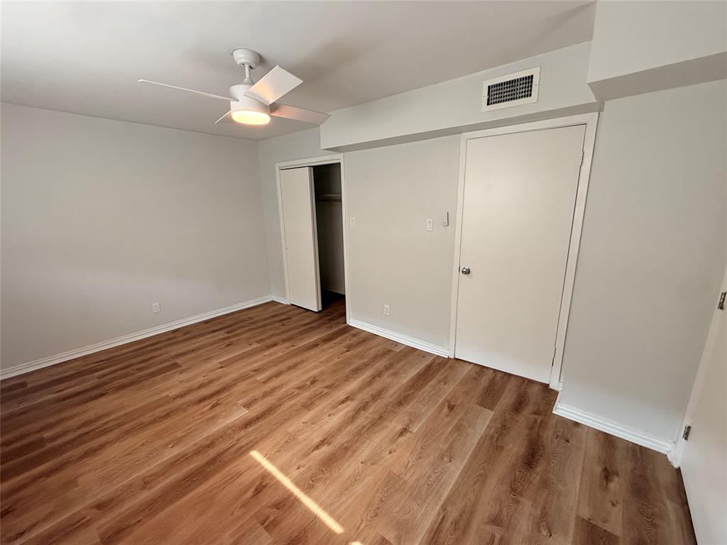 3925 Inwood Road, Unit 1017 Dallas, TX 75209 - Photo 19 of 23 wooden floor in an empty room with a window