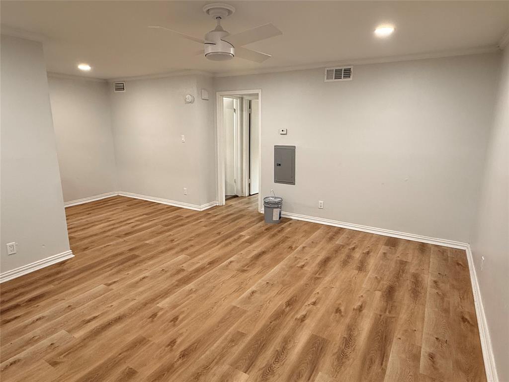 3925 Inwood Road, Unit 1017 Dallas, TX 75209 - Photo 4 of 23 an empty room with wooden floor and windows