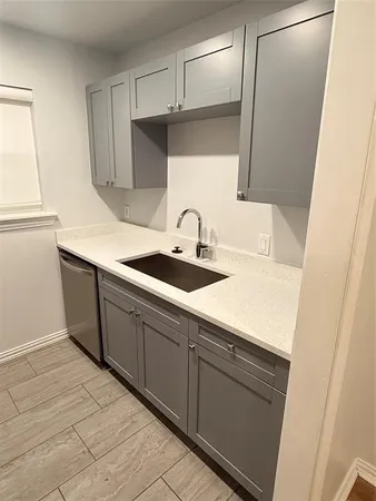 a kitchen with a sink and cabinets