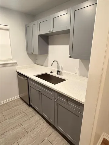 a kitchen with a sink and cabinets