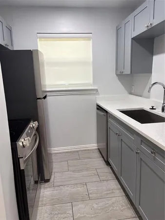 a kitchen with a refrigerator and a sink