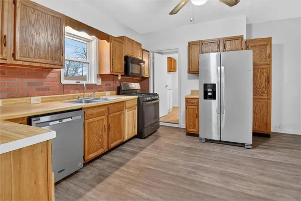 a kitchen with stainless steel appliances a refrigerator stove and sink