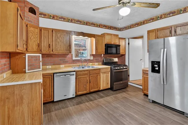 a kitchen with a refrigerator stove and sink