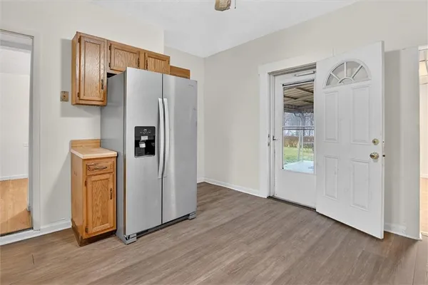 an empty room with wooden floor and a window