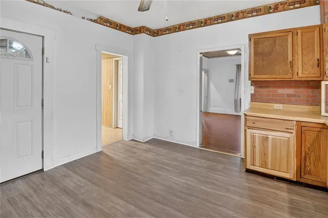 a view of empty room with wooden floor and cabinet
