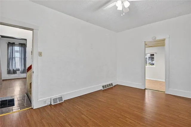 wooden floor in an empty room with a window