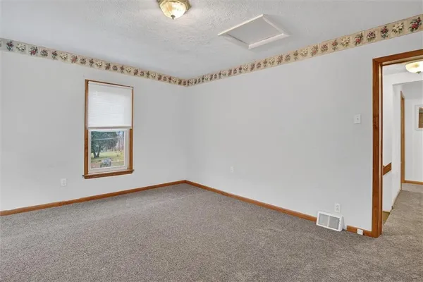 a view of an empty room with a window