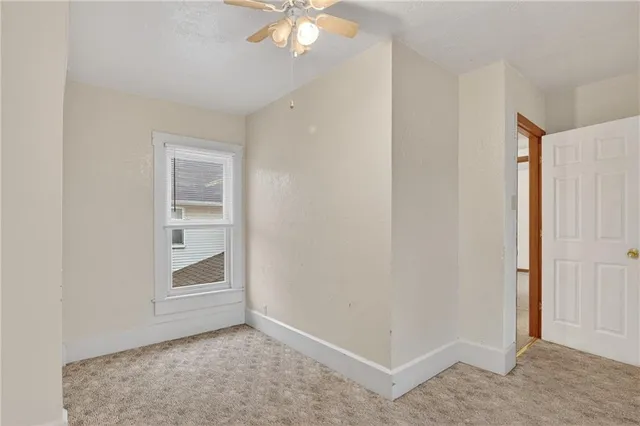 an empty room with windows and closet