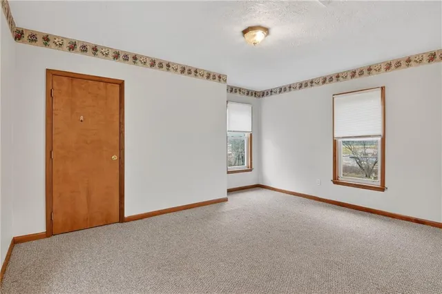 a view of an empty room and a window