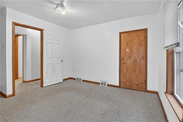 an empty room with closet area