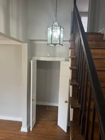 a view of entryway and hall with wooden floor