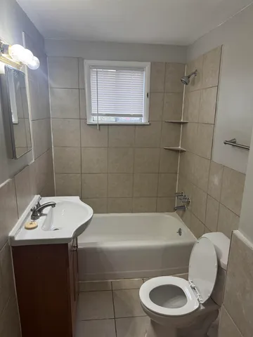 a bathroom with a sink a toilet and bathtub